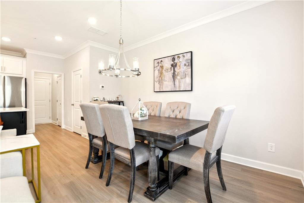 765 Trevett Way Marietta, GA 30066 - Photo 10 of 46 a view of a dining room with furniture and wooden floor