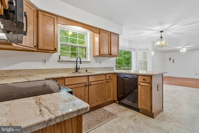 a kitchen with stainless steel appliances granite countertop a sink and a stove