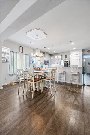 a large kitchen with a table and chairs