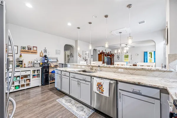 a kitchen with stainless steel appliances granite countertop a sink and stove