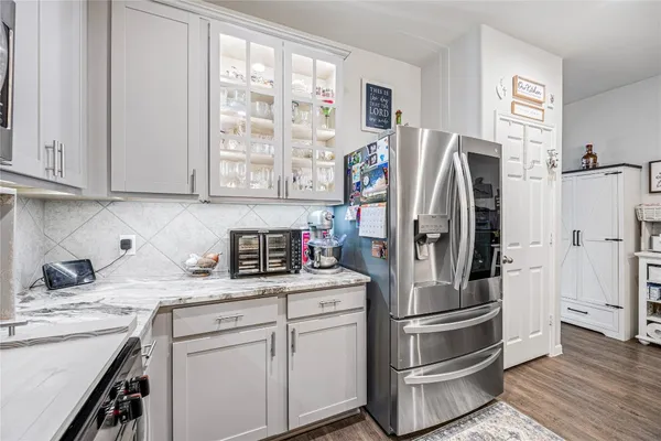 a kitchen with stainless steel appliances granite countertop a refrigerator sink and cabinets