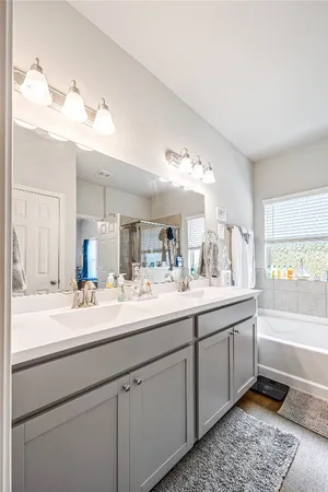 a bathroom with a double vanity sink and a mirror