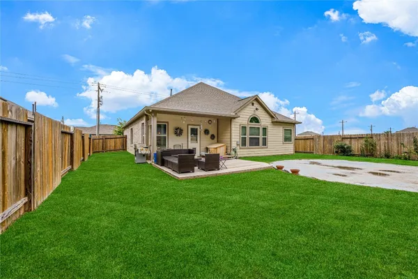 a view of a house with a yard and sitting area