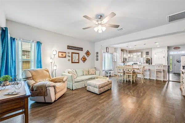 a living room with furniture and wooden floor