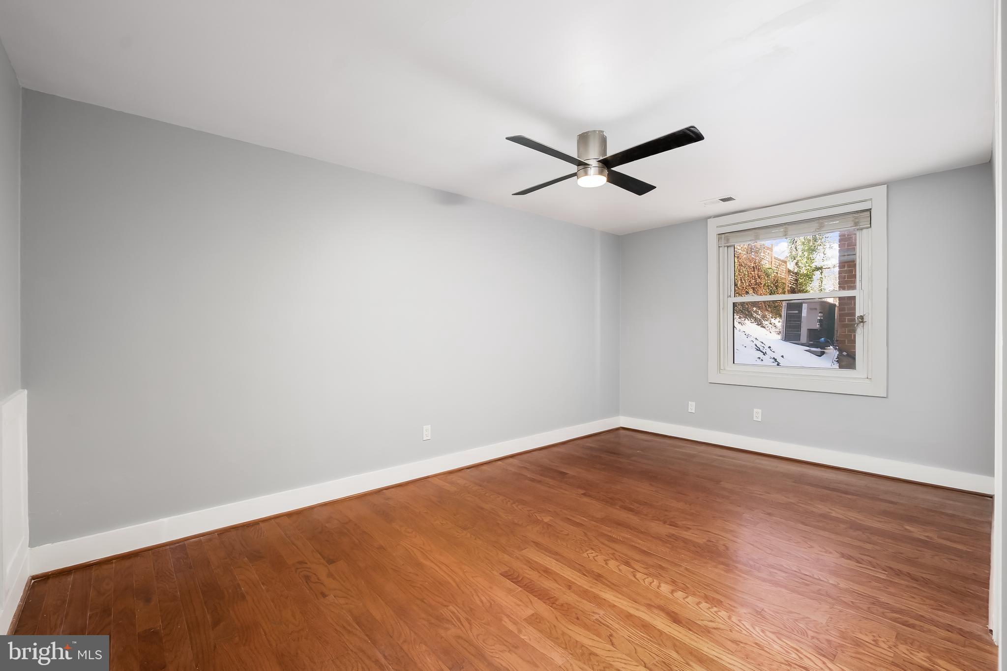 4840 MacArthur Boulevard Northwest, Unit 307 Washington, DC 20007 - Photo 12 of 21 a view of empty room with wooden floor and fan