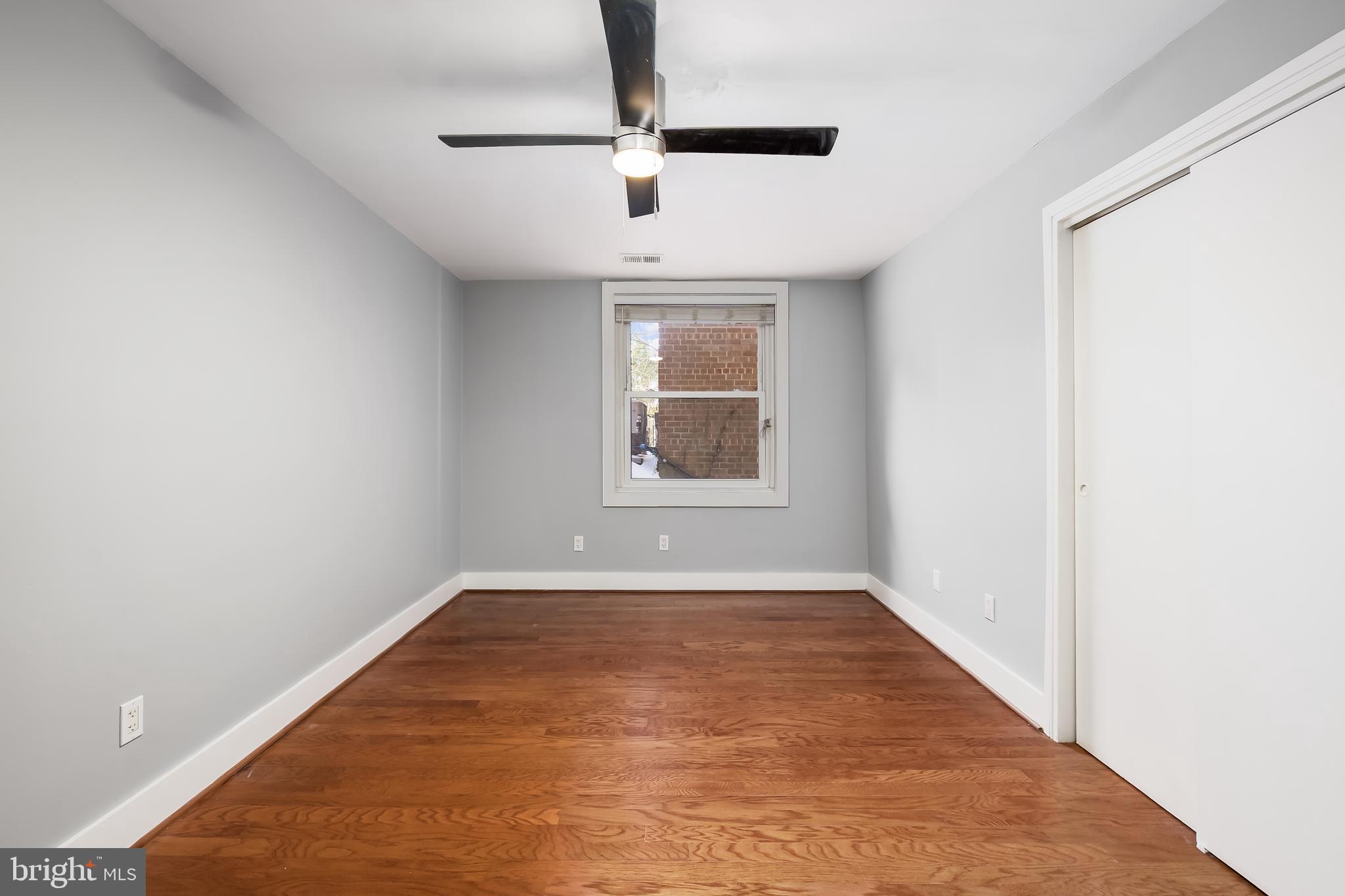4840 MacArthur Boulevard Northwest, Unit 307 Washington, DC 20007 - Photo 13 of 21 an empty room with windows and ceiling fan