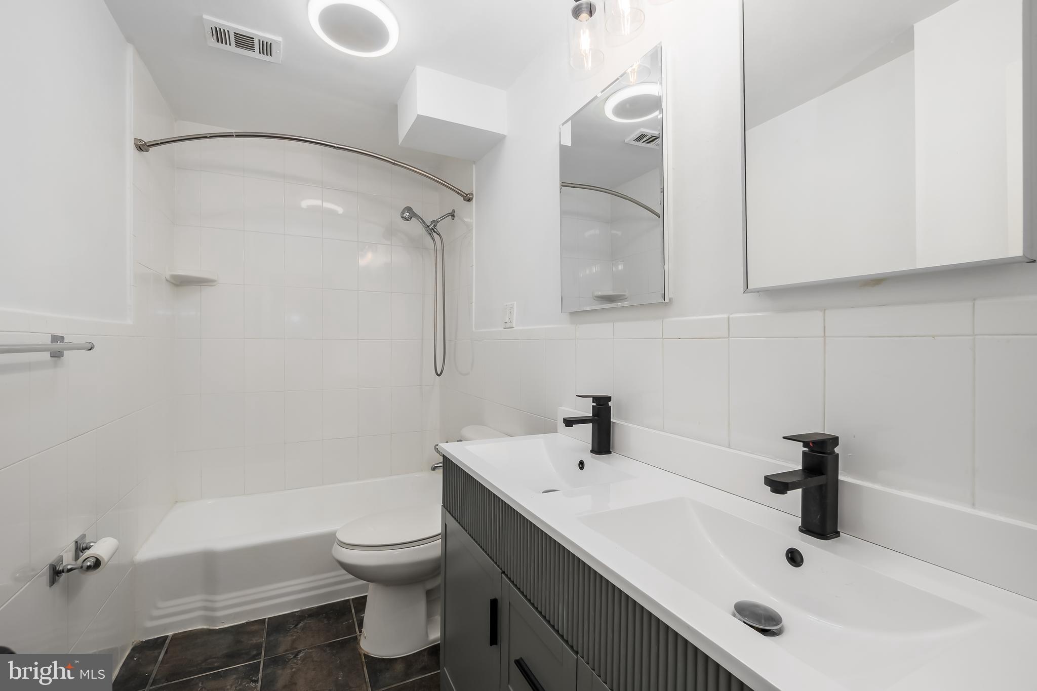 4840 MacArthur Boulevard Northwest, Unit 307 Washington, DC 20007 - Photo 15 of 21 a bathroom with a sink toilet and shower