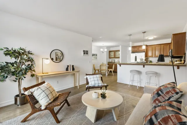 a living room with furniture and kitchen view