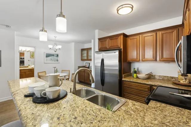 a kitchen with a refrigerator and a sink