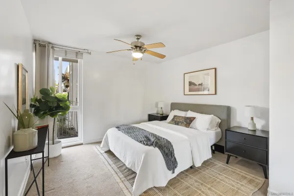 a bedroom with a bed potted plant with the wooden floor