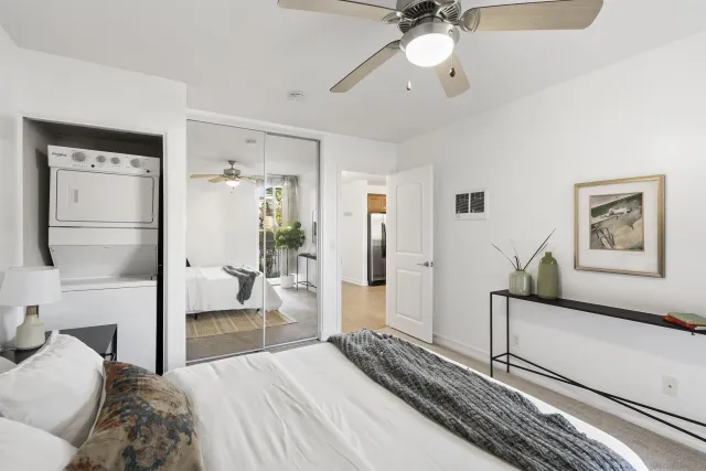 a bedroom with a large bed and a chandelier