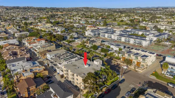 an aerial view of residential houses with city view