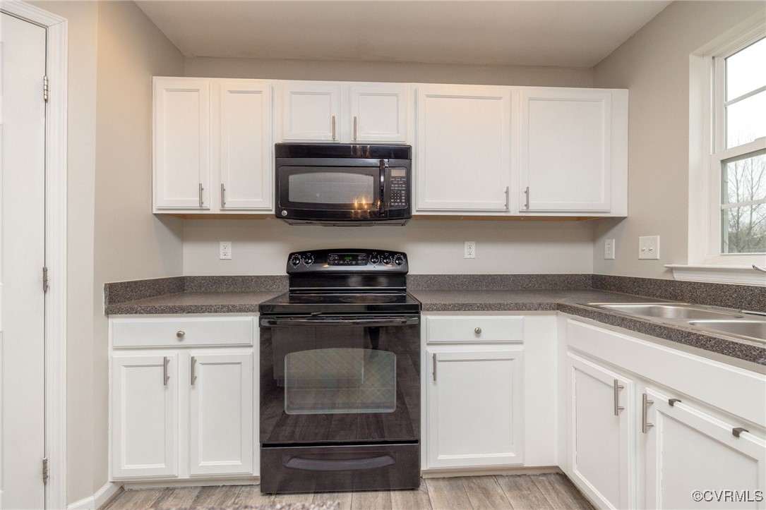 5125 Glenbeigh Road Richmond, VA 23234 - Photo 17 of 40 a kitchen with white cabinets and appliances