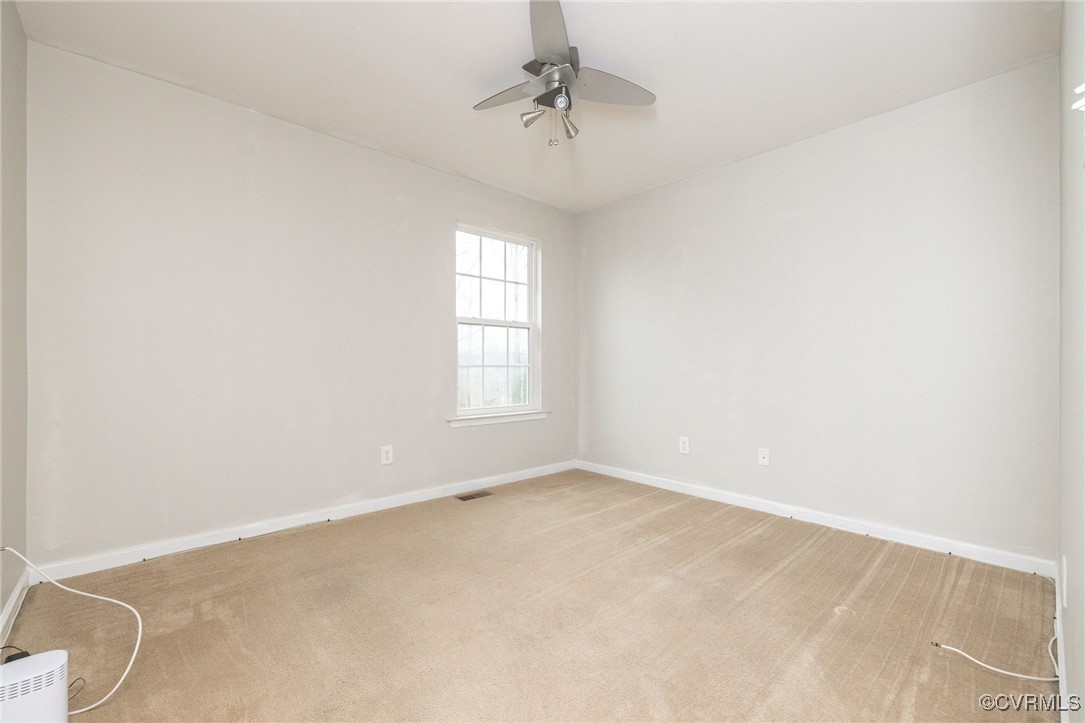 5125 Glenbeigh Road Richmond, VA 23234 - Photo 20 of 40 an empty room with windows and chandelier fan