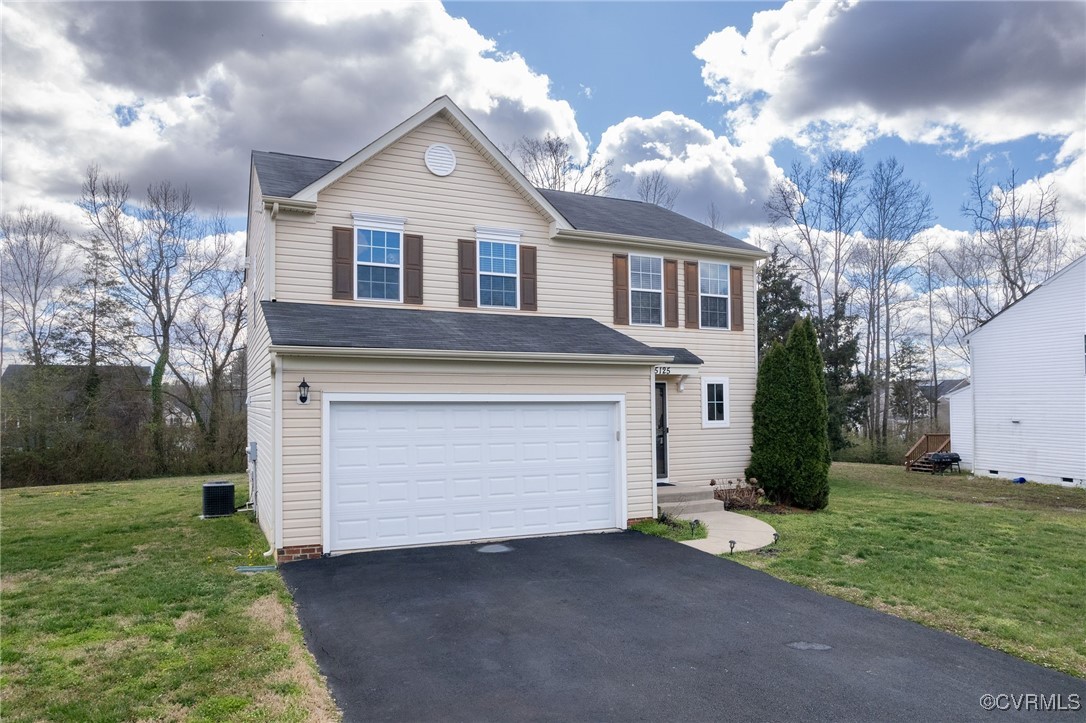 5125 Glenbeigh Road Richmond, VA 23234 - Photo 2 of 40 a front view of a house with a yard and garage