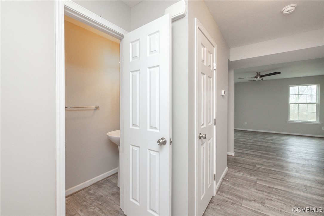 5125 Glenbeigh Road Richmond, VA 23234 - Photo 6 of 40 a view of a hallway with wooden floor and a bathroom