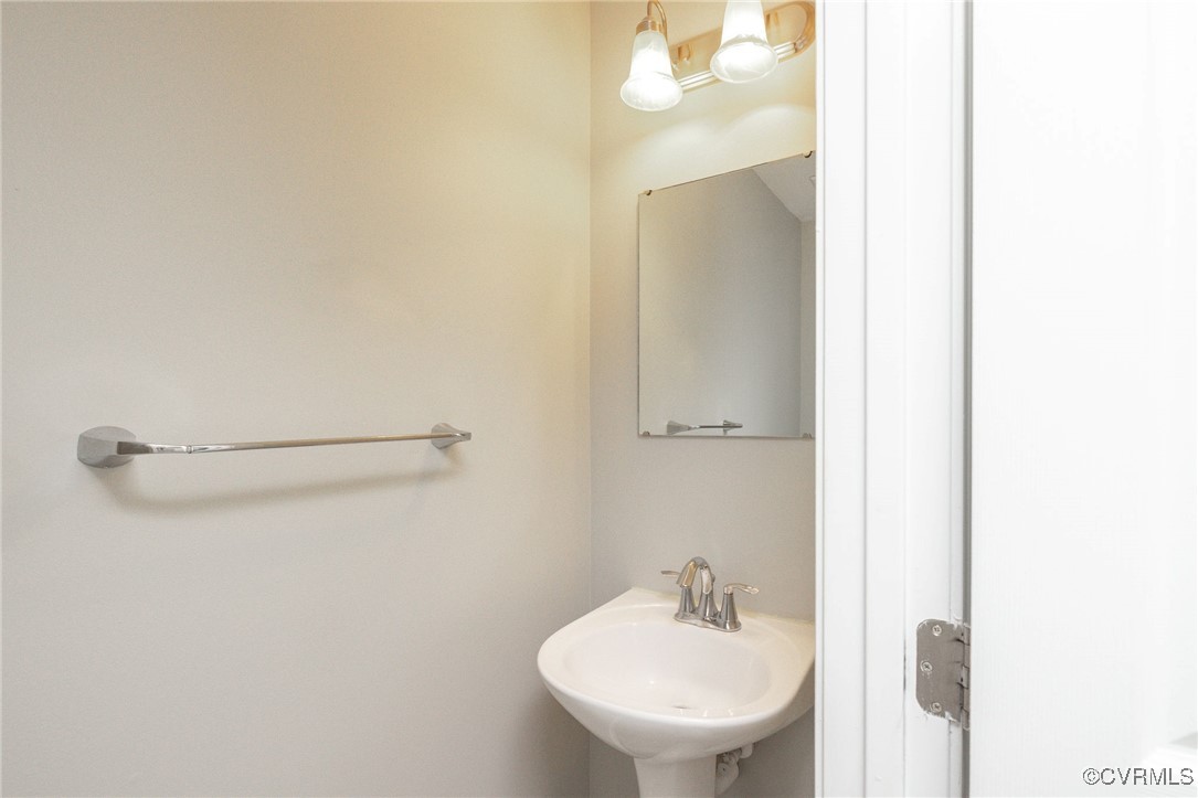 5125 Glenbeigh Road Richmond, VA 23234 - Photo 7 of 40 a bathroom with a sink a mirror and a toilet