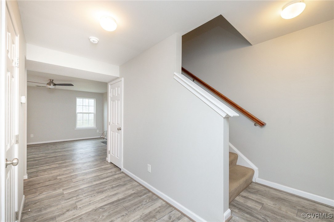 5125 Glenbeigh Road Richmond, VA 23234 - Photo 8 of 40 a view of hallway with stairs and wooden floor