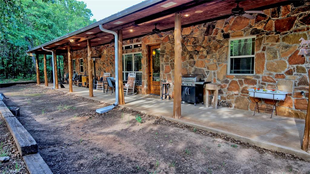 4509 Lazy E Road St. Jo, TX 76265 - Photo 22 of 39 a view of a house with porch and sitting area