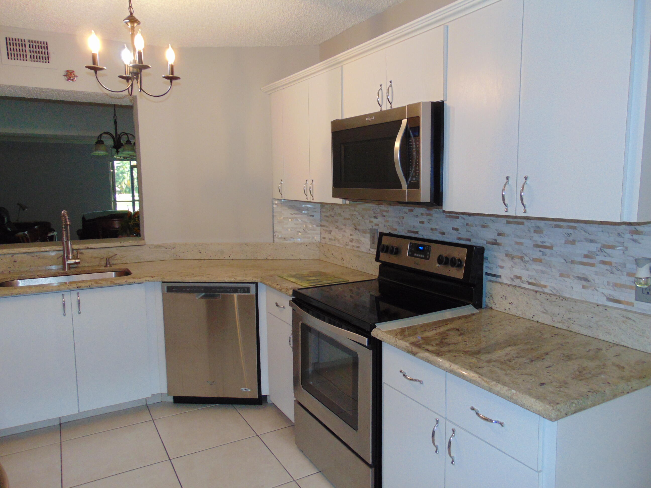 9220 Southwest 14th Street, Unit 3103 Boca Raton, FL 33428 - Photo 1 of 58 a kitchen with a sink and a microwave