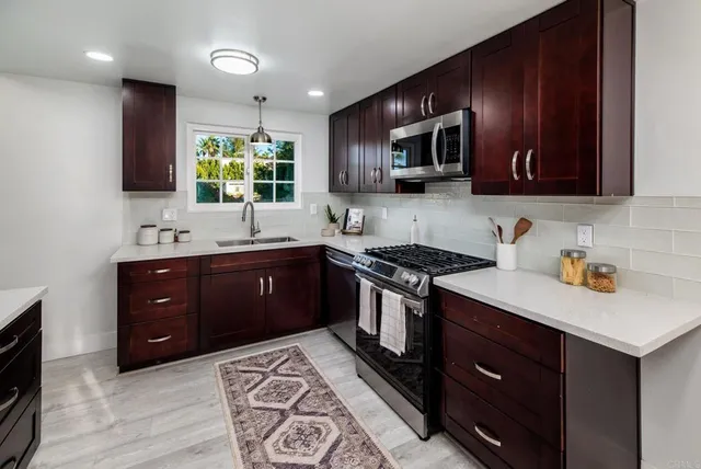 a kitchen with a sink stove and microwave