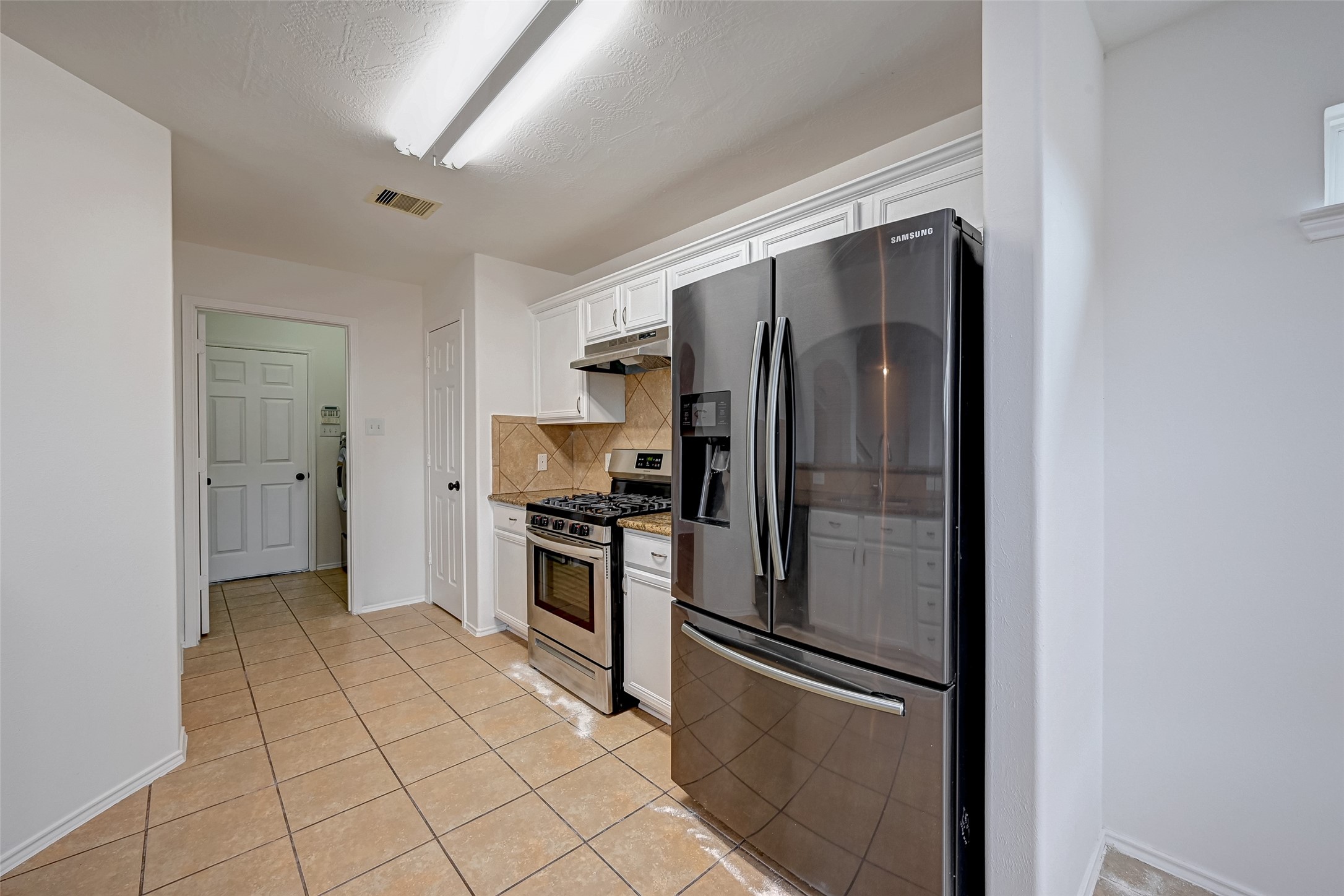 6906 Anson Point Lane Houston, TX 77040 - Photo 12 of 31 a kitchen with stainless steel appliances granite countertop a refrigerator and a sink