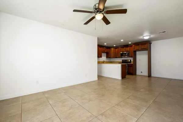 a kitchen with stainless steel appliances granite countertop a stove top oven a sink and a refrigerator