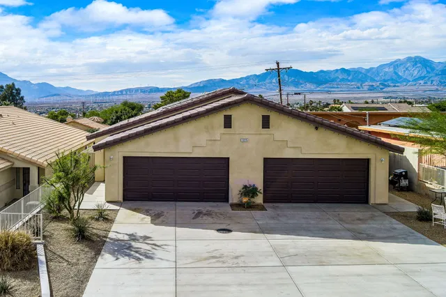 an aerial view of a houses with a city view
