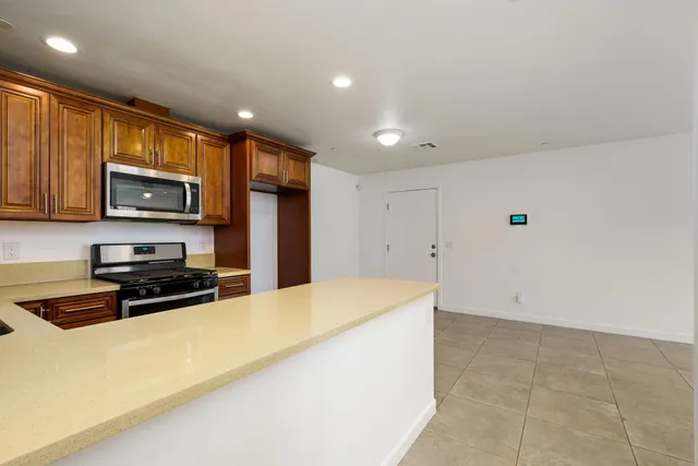 a bathroom with a granite countertop sink toilet a shower and a mirror