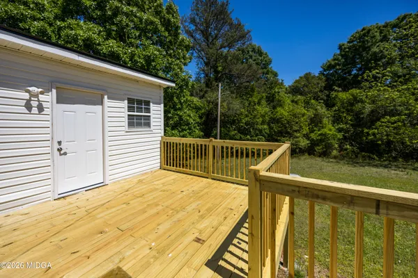 a backyard of a house with yard and outdoor seating