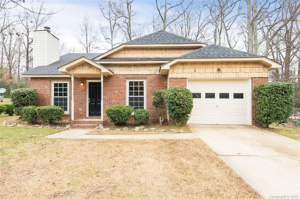 5919 Hunters Crossing Lane Charlotte, NC 28215 - Photo 1 of 14 a front view of a house with a yard and garage