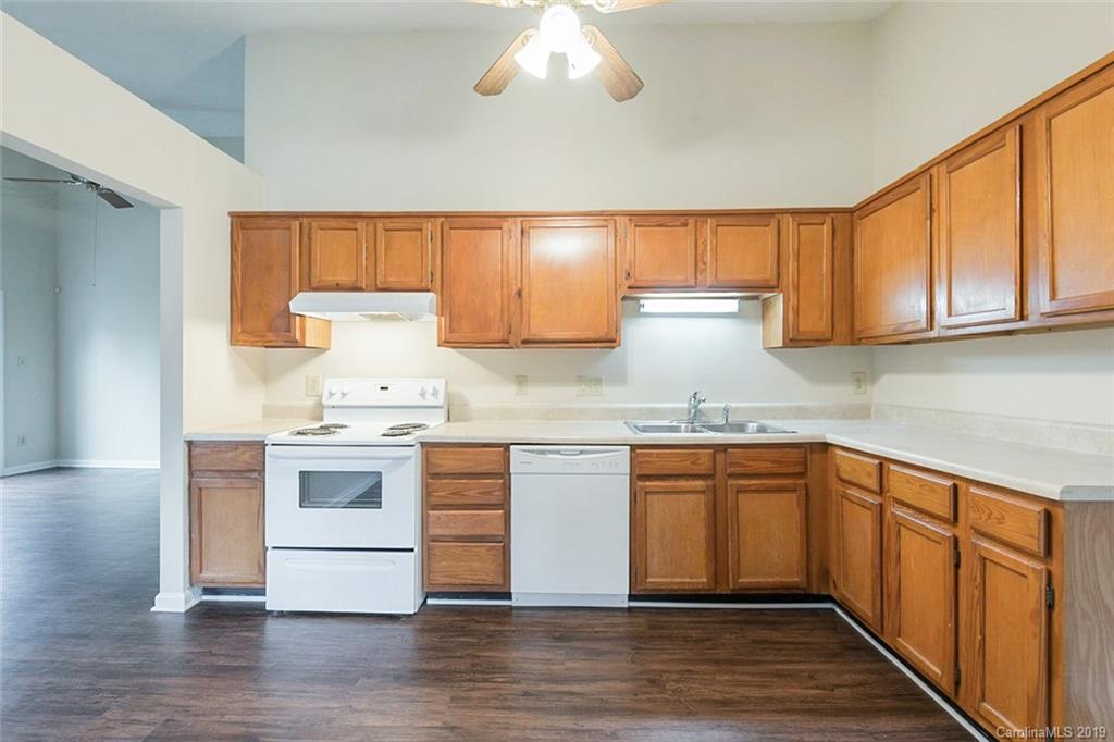 5919 Hunters Crossing Lane Charlotte, NC 28215 - Photo 2 of 14 a kitchen with stainless steel appliances granite countertop a sink stove and refrigerator