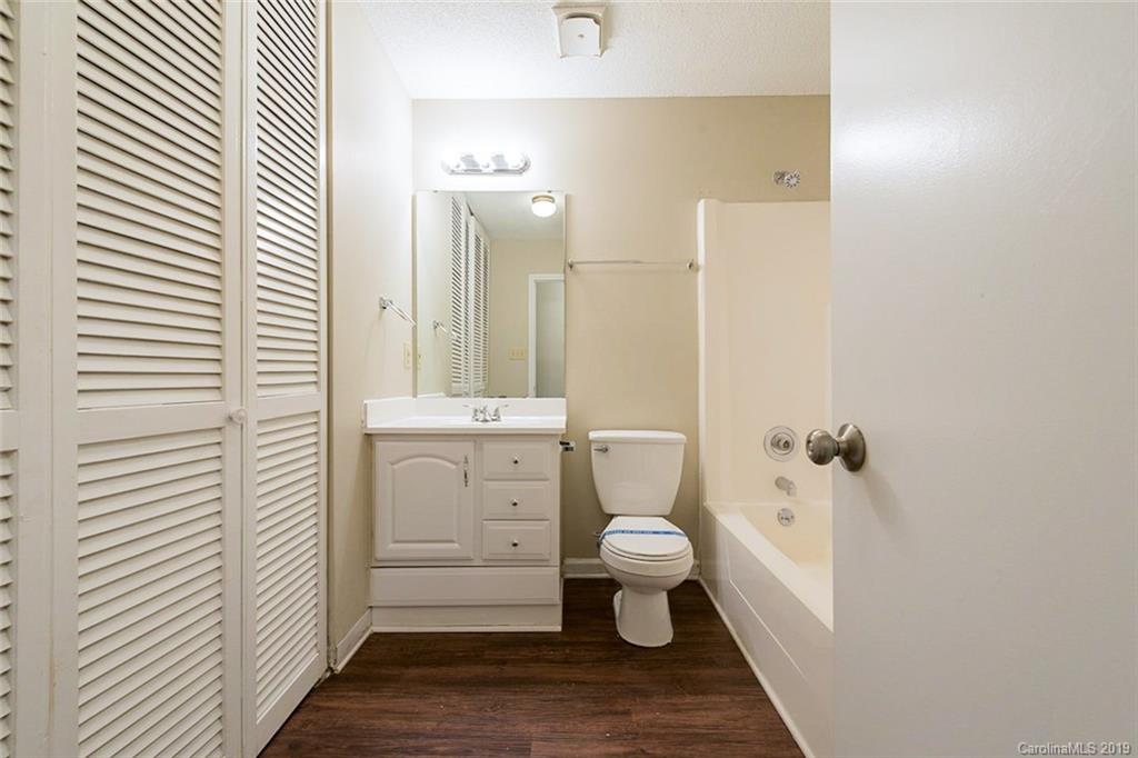 5919 Hunters Crossing Lane Charlotte, NC 28215 - Photo 11 of 14 a bathroom with a sink toilet and shower