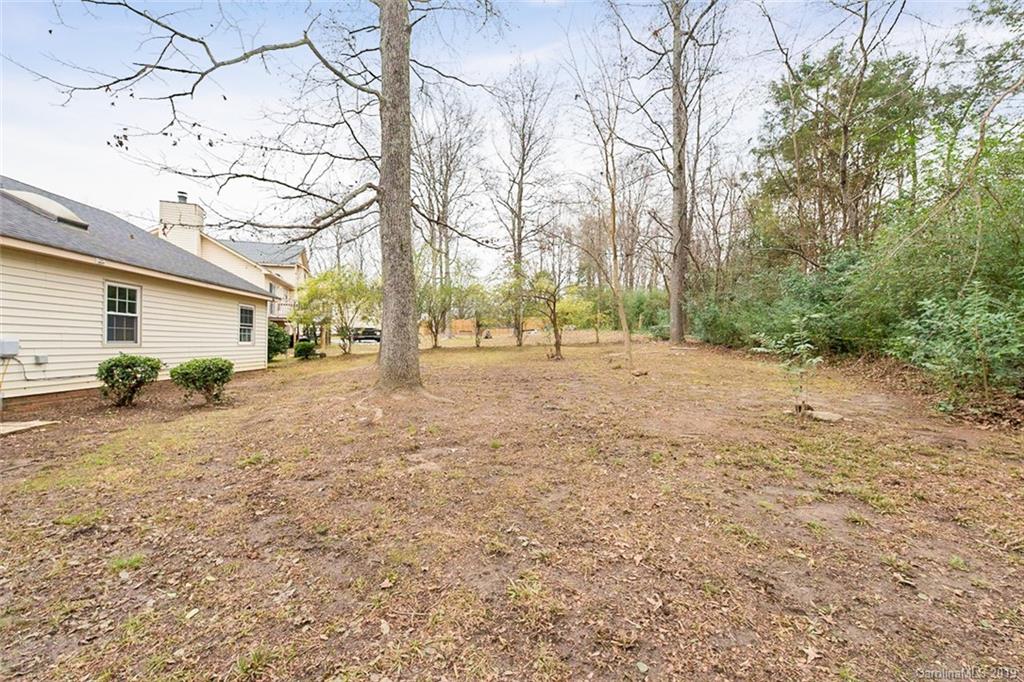 5919 Hunters Crossing Lane Charlotte, NC 28215 - Photo 12 of 14 a view of dirt yard with a tree
