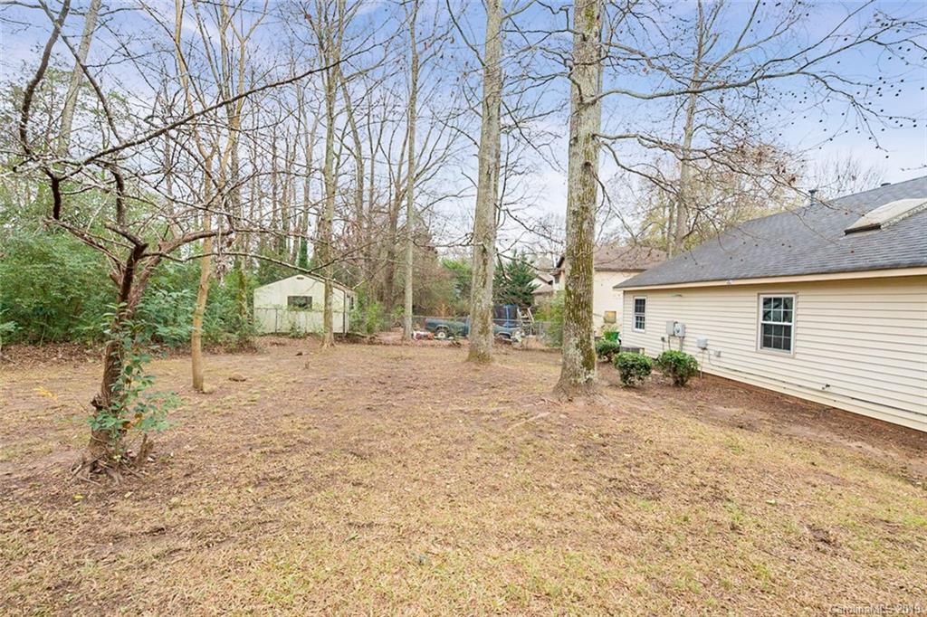 5919 Hunters Crossing Lane Charlotte, NC 28215 - Photo 13 of 14 a view of a yard with potted plants and large tree