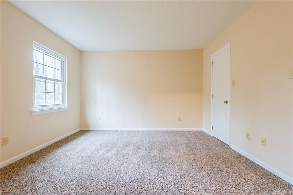 5919 Hunters Crossing Lane Charlotte, NC 28215 - Photo 9 of 14 an empty room with windows