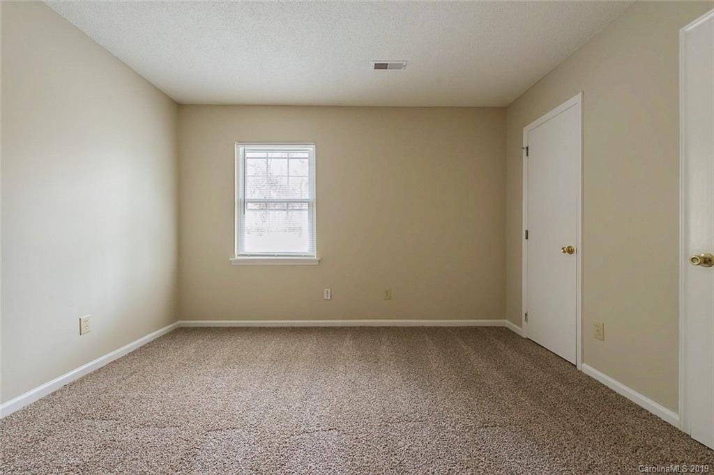 5919 Hunters Crossing Lane Charlotte, NC 28215 - Photo 10 of 14 an empty room with a window