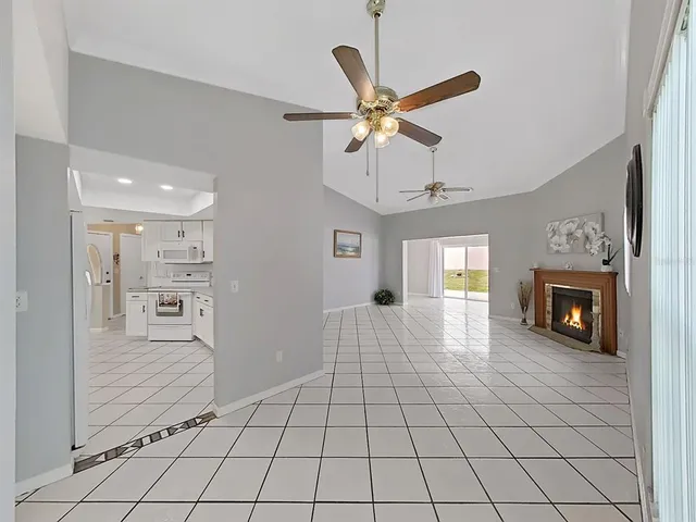 a view of an empty room and window with wooden floor