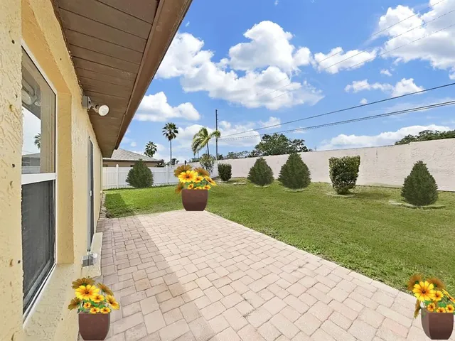 a view of a house with a backyard