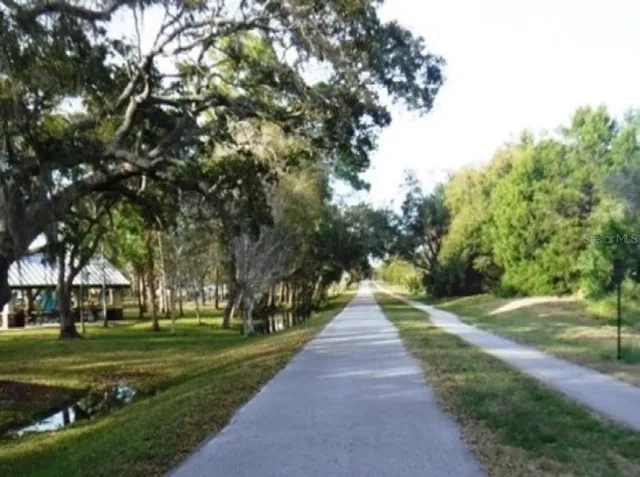 an aerial view of a golf course with a lake view