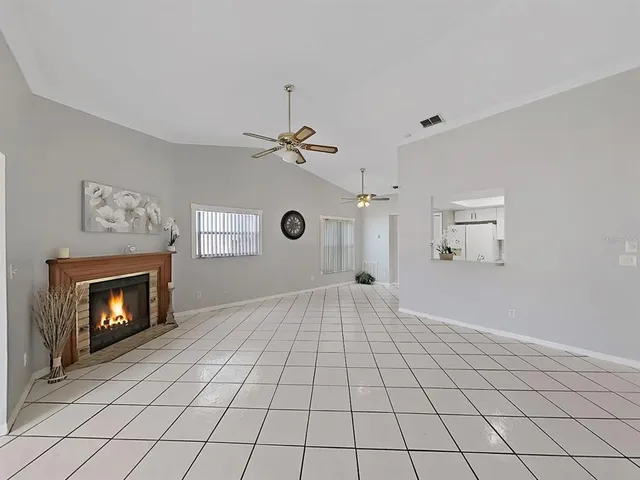 a view of an empty room with a fireplace