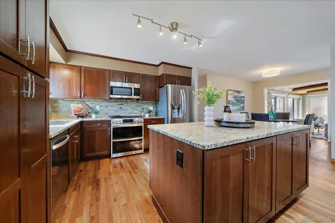 a kitchen with stainless steel appliances granite countertop a stove refrigerator and a microwave
