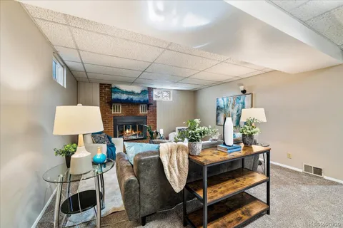 a dining room with furniture and a lamp