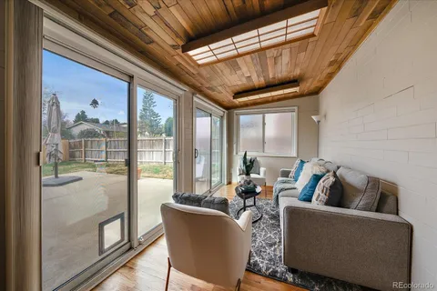 a living room with furniture and a floor to ceiling window