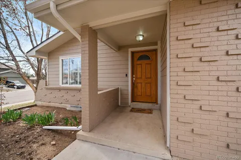 a view of front door of house with stairs