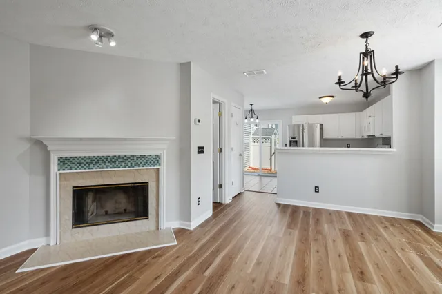 a view of a kitchen and an empty room