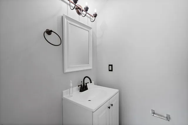 a bathroom with a sink and mirror
