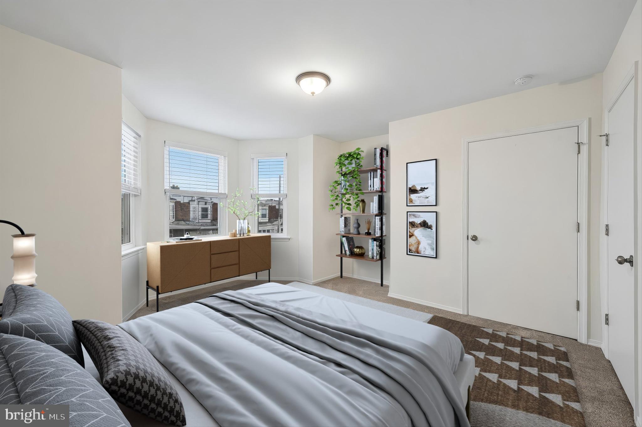 6129 Spruce Street Philadelphia, PA 19139 - Photo 12 of 18 a bedroom with a large bed and a window
