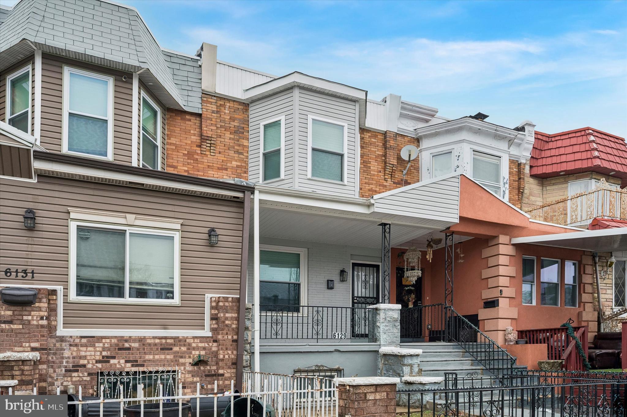 6129 Spruce Street Philadelphia, PA 19139 - Photo 2 of 18 a front view of a residential apartment building with a yard