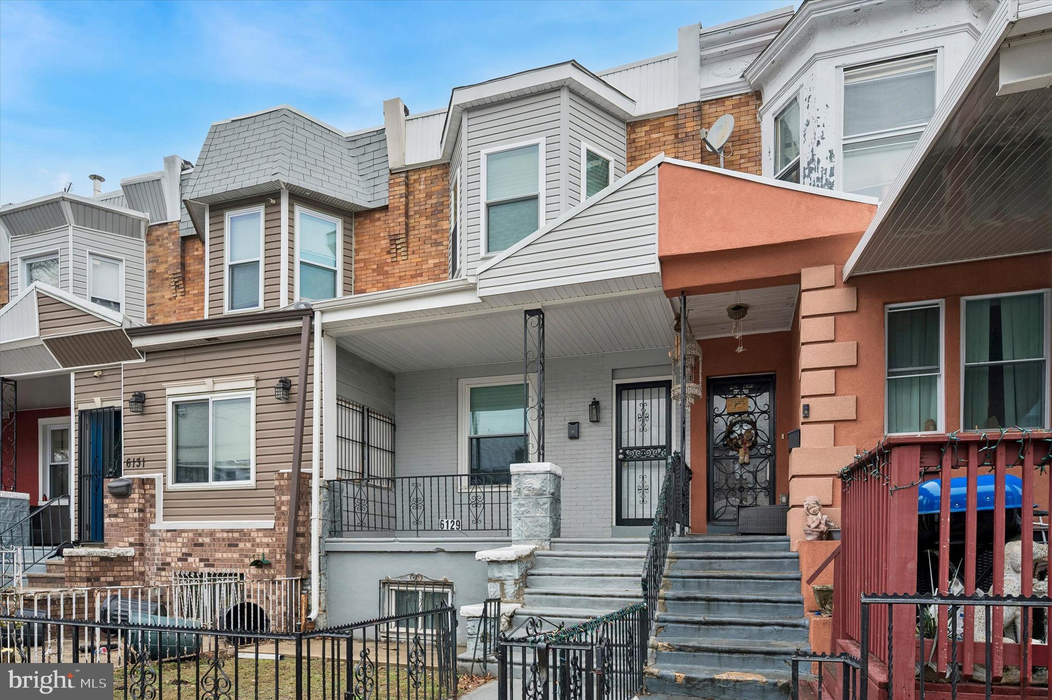 6129 Spruce Street Philadelphia, PA 19139 - Photo 3 of 18 a view of a house with large windows and a small yard